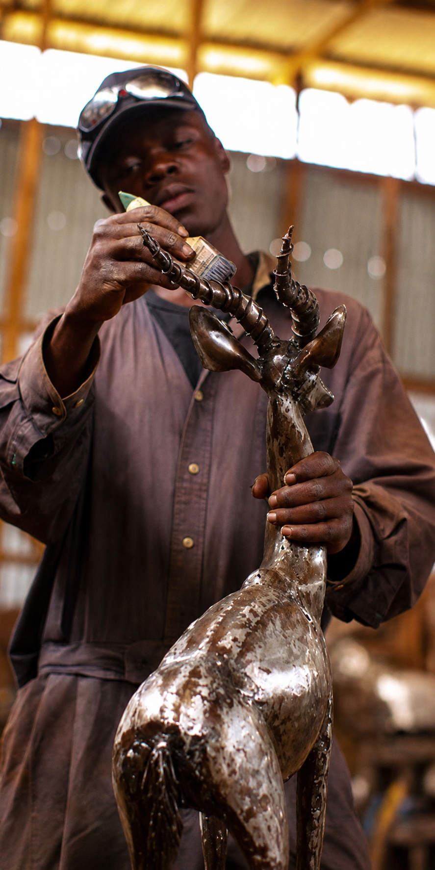 Pangea artisan shaping metal sculpture framework