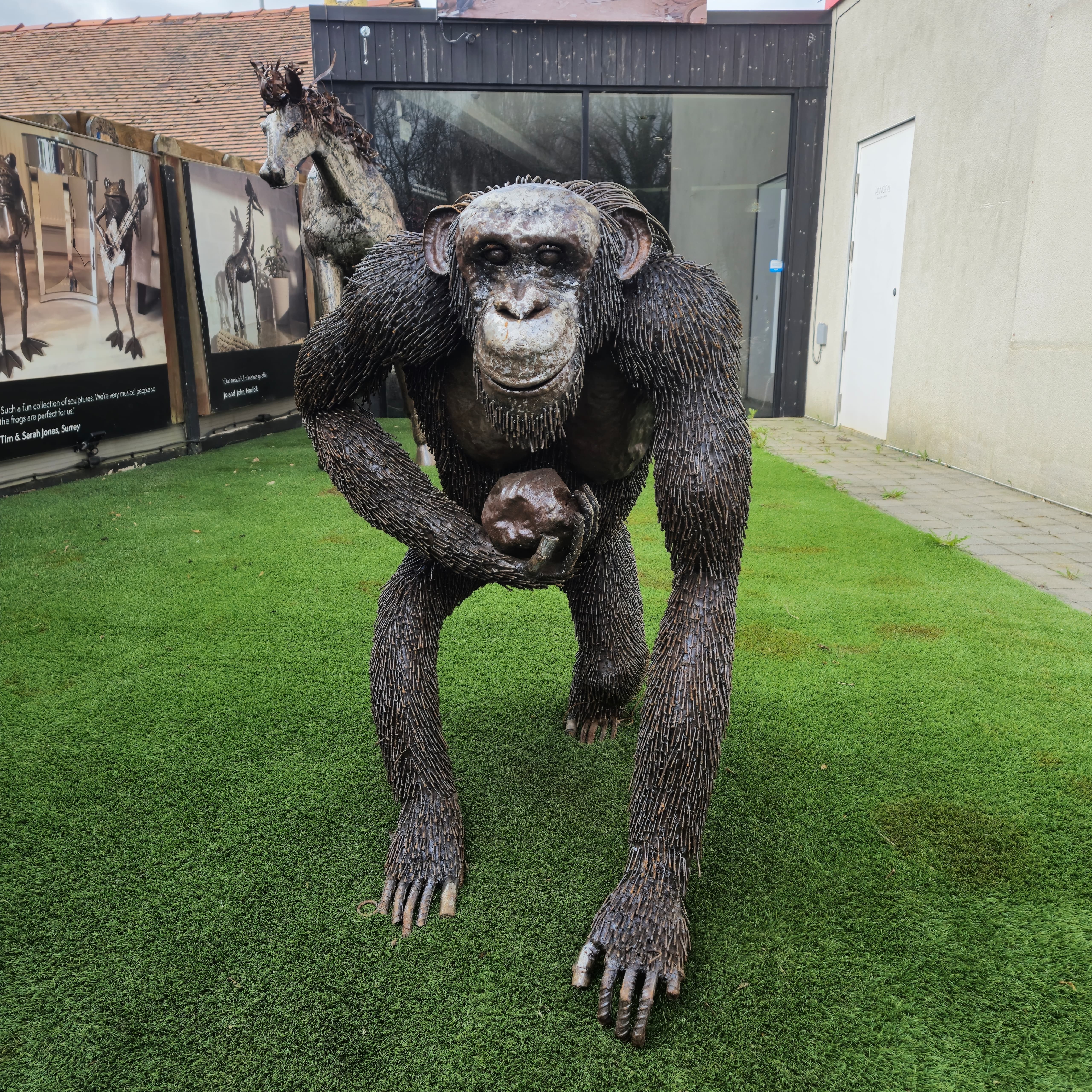 Sitting Chimp Metal Sculpture (Carrying Rock)