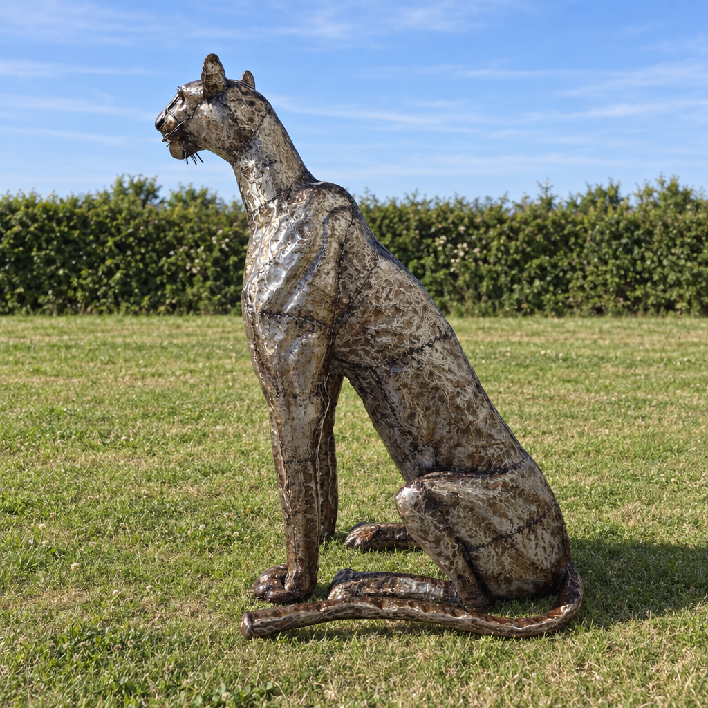 Sitting Cheetah Sculpture - Head Up, three-quarter view in an outdoor setting