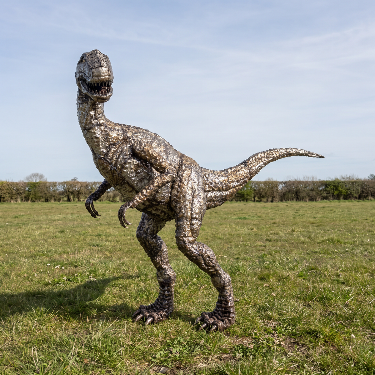 One-of-one metal Raptor sculpture displayed outdoors, front view