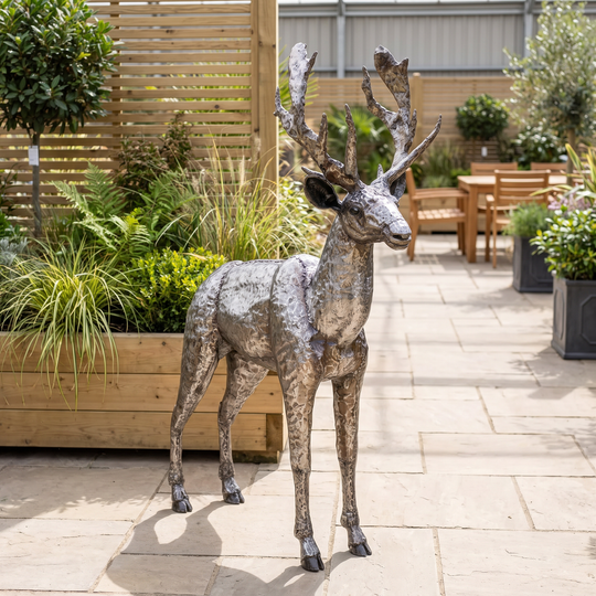 Handcrafted welded-steel stag sculpture displayed in an outdoor-living retail setting.